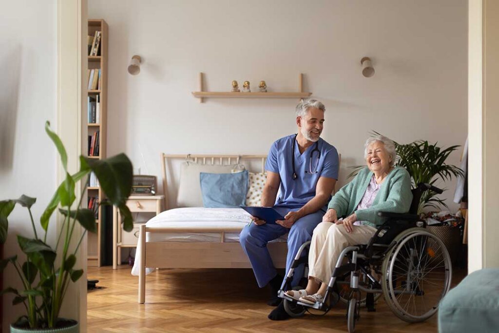 Older adult and family members reviewing care notes together at a kitchen table.