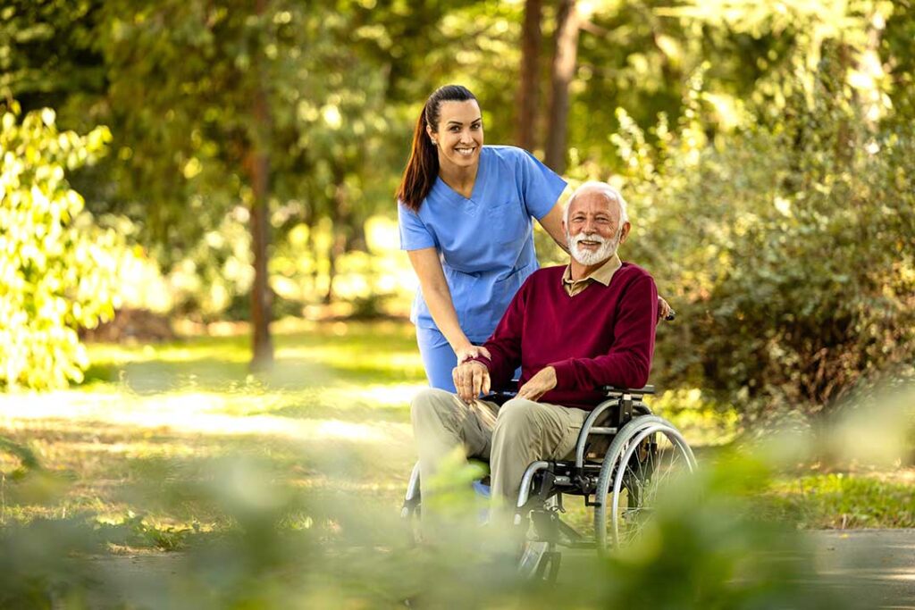 Older adult reviewing a monthly care budget with a family member at a kitchen table.